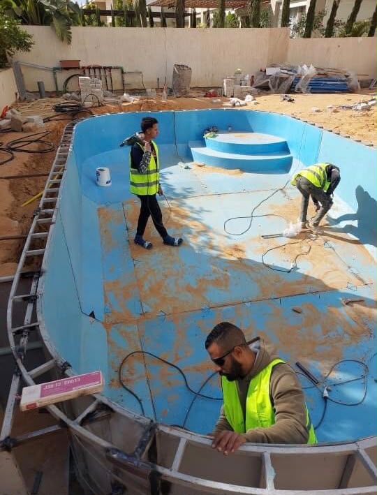 Turquoise team working on a pool installation