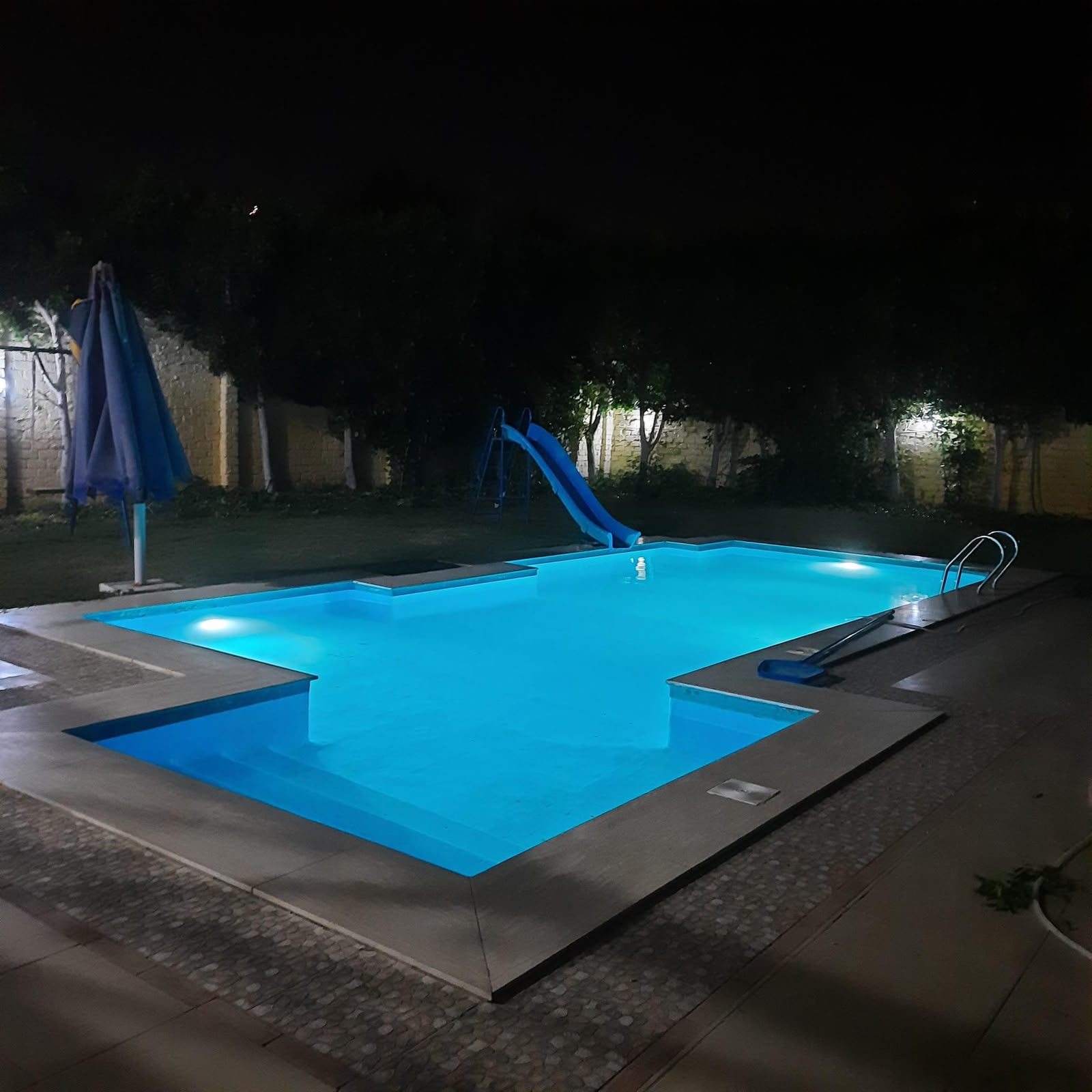 Swimming pool at night with underwater lighting